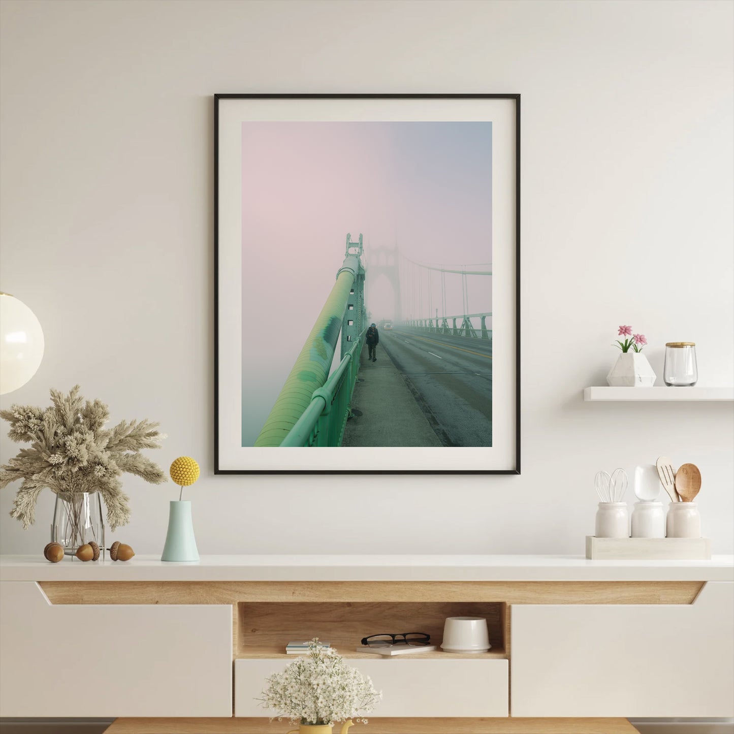 a framed photograph of a man walking alone on the st johns bridge on a very foggy morning