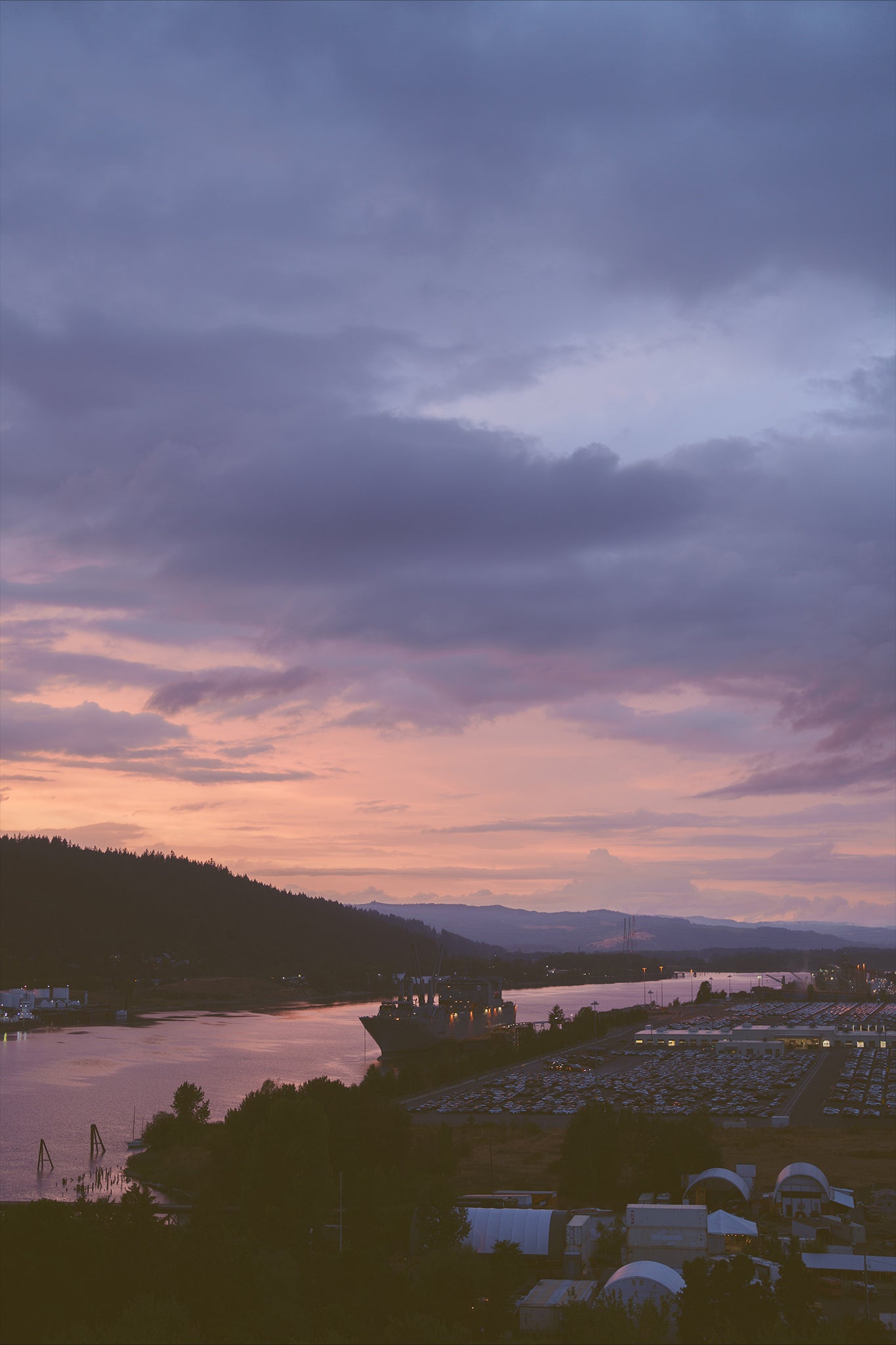 a beautiful sunset on the Willamette river in Portland with a large ship on the water