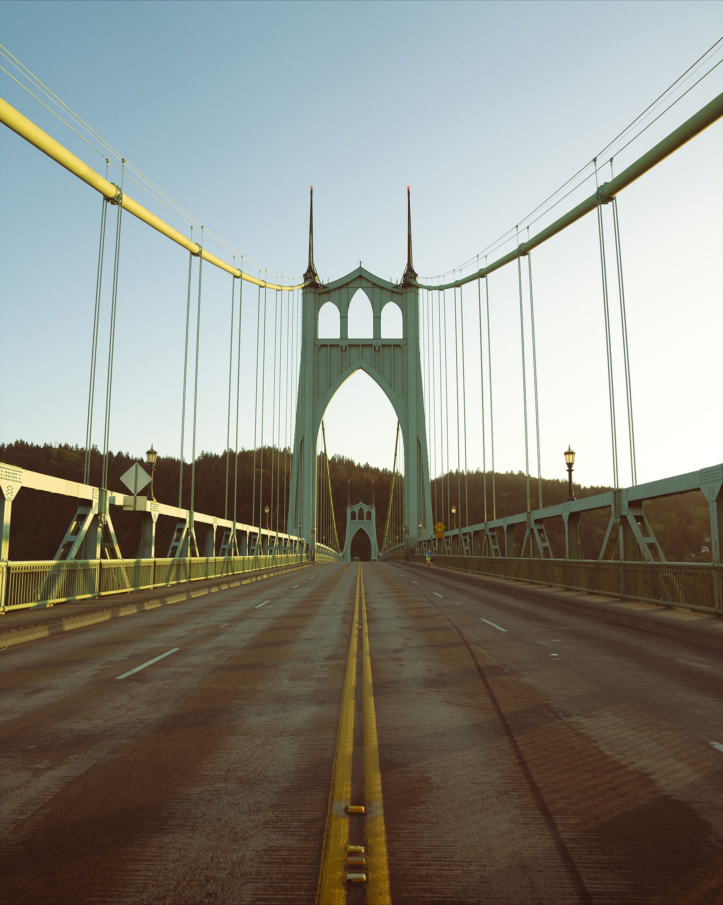 the st johns bridge in portland oregon from the middle of the road on a hot summer day