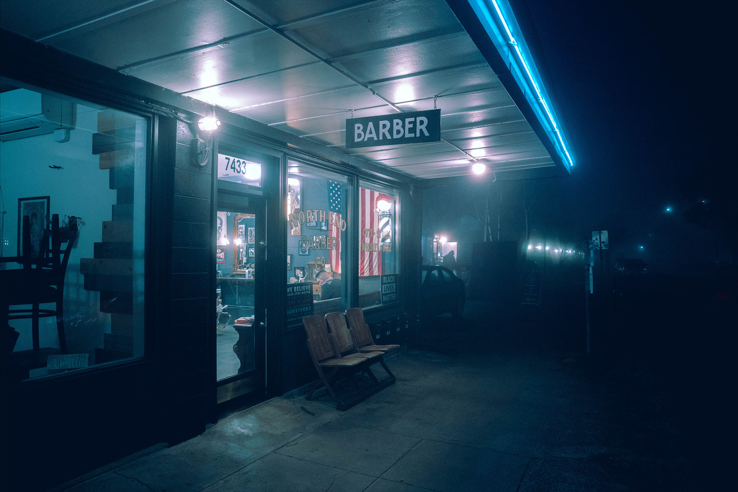 a barber shop in st johns of portland oregon on a foggy night