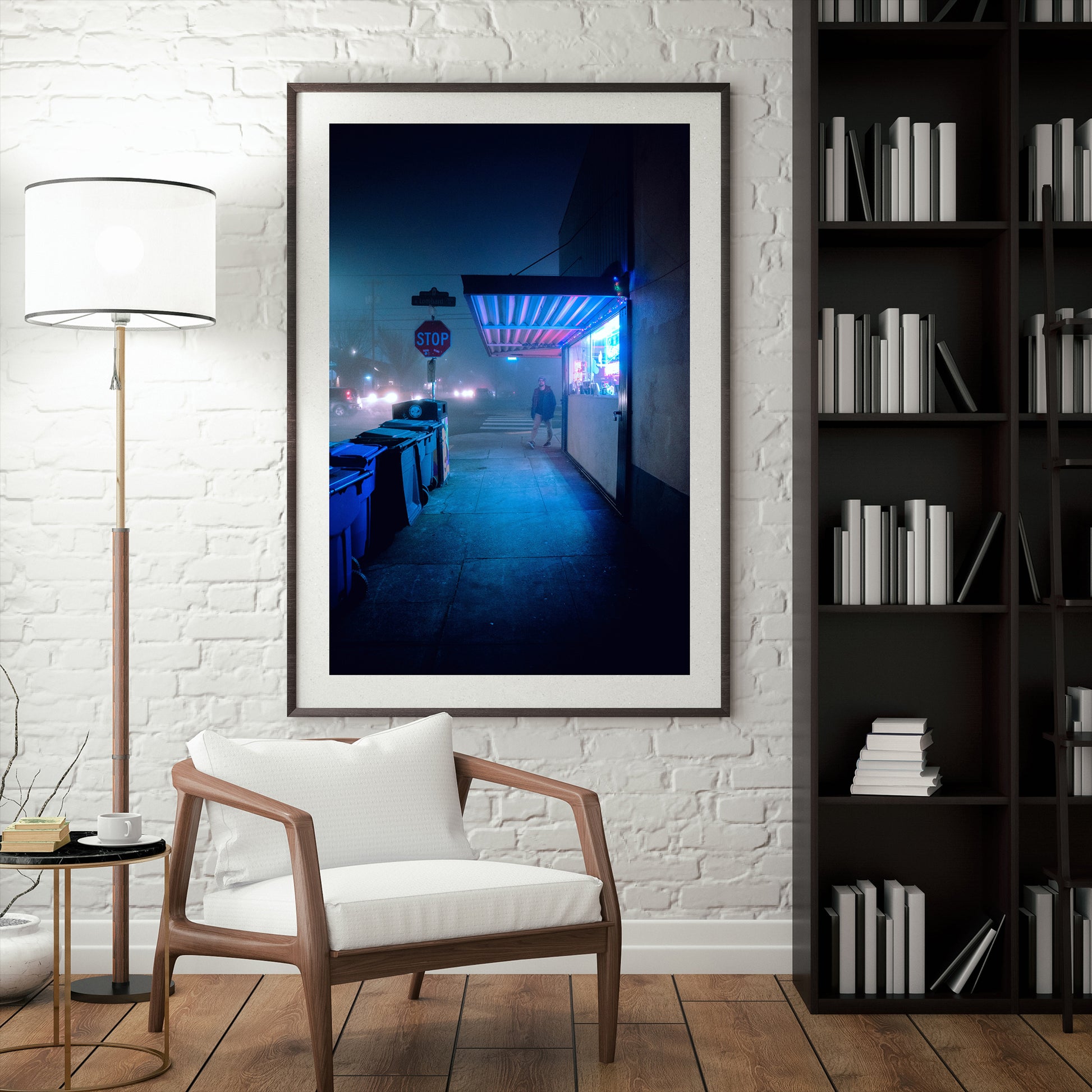 a framed photograph of a man walking on the sidewalk on a foggy night in st johns with neon lights coming out of a shop