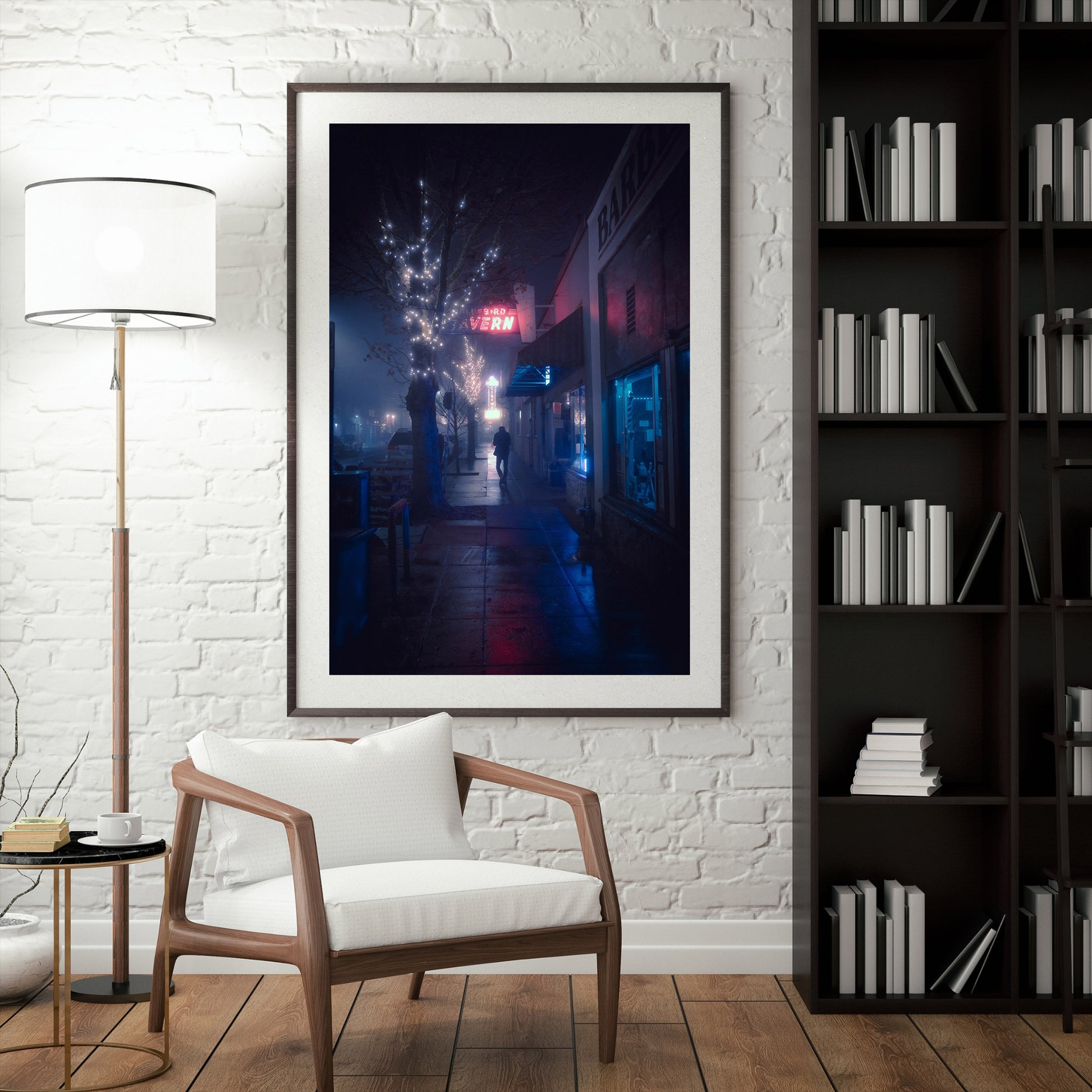 A mock-up of a framed photograph of a man walking alone in an empty street on a foggy night.