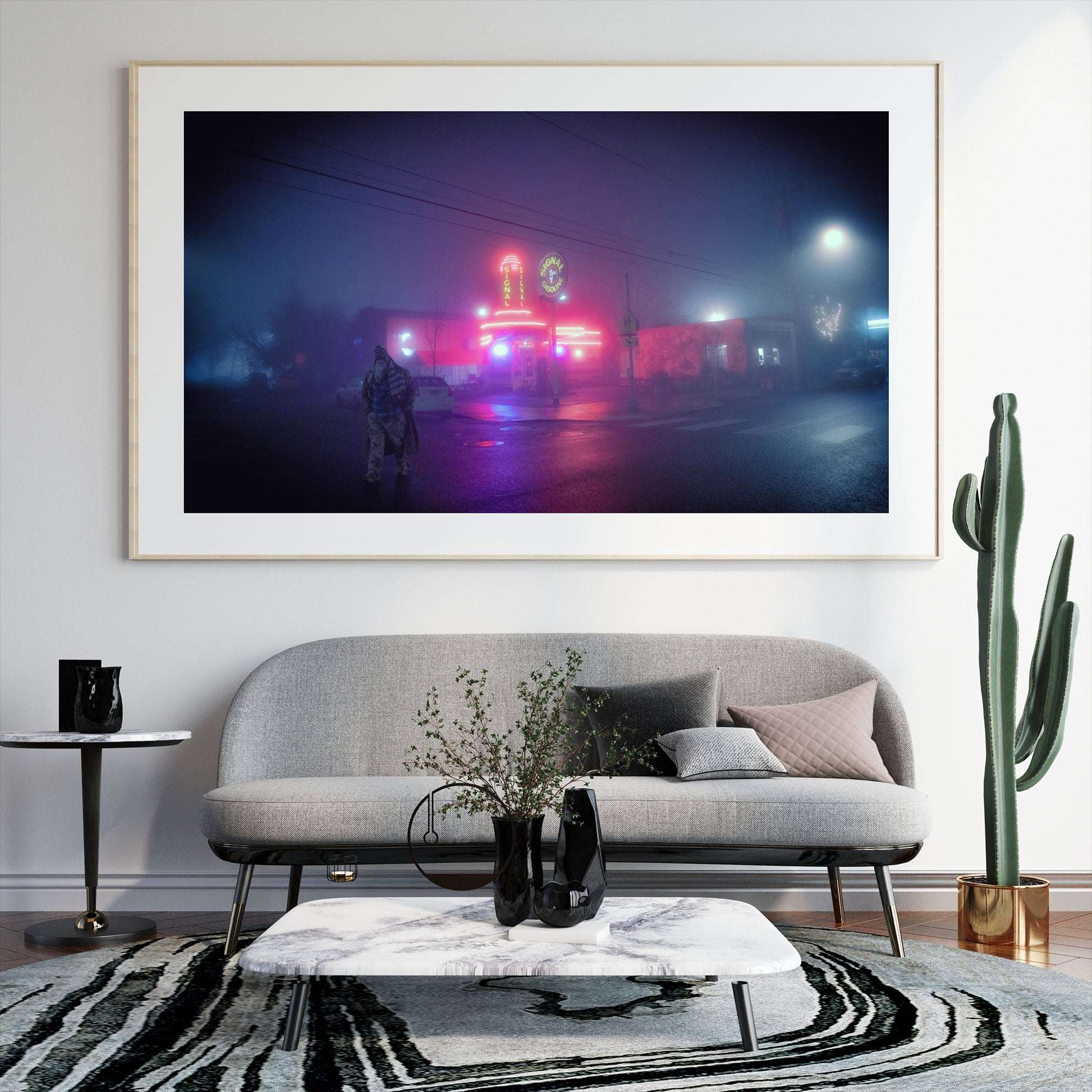 a framed photograph of a man walking away from a gas station with neon lights on a very foggy night