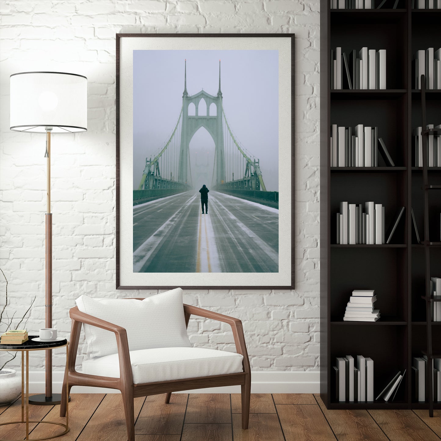 a framed photograph of a man in the middle of the road on the st johns bridge taking a picture during a snowstorm