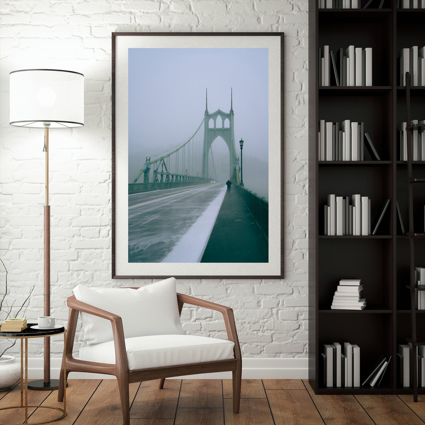 a framed photograph of a man walking across the st johns bridge during a snowstorm in portland