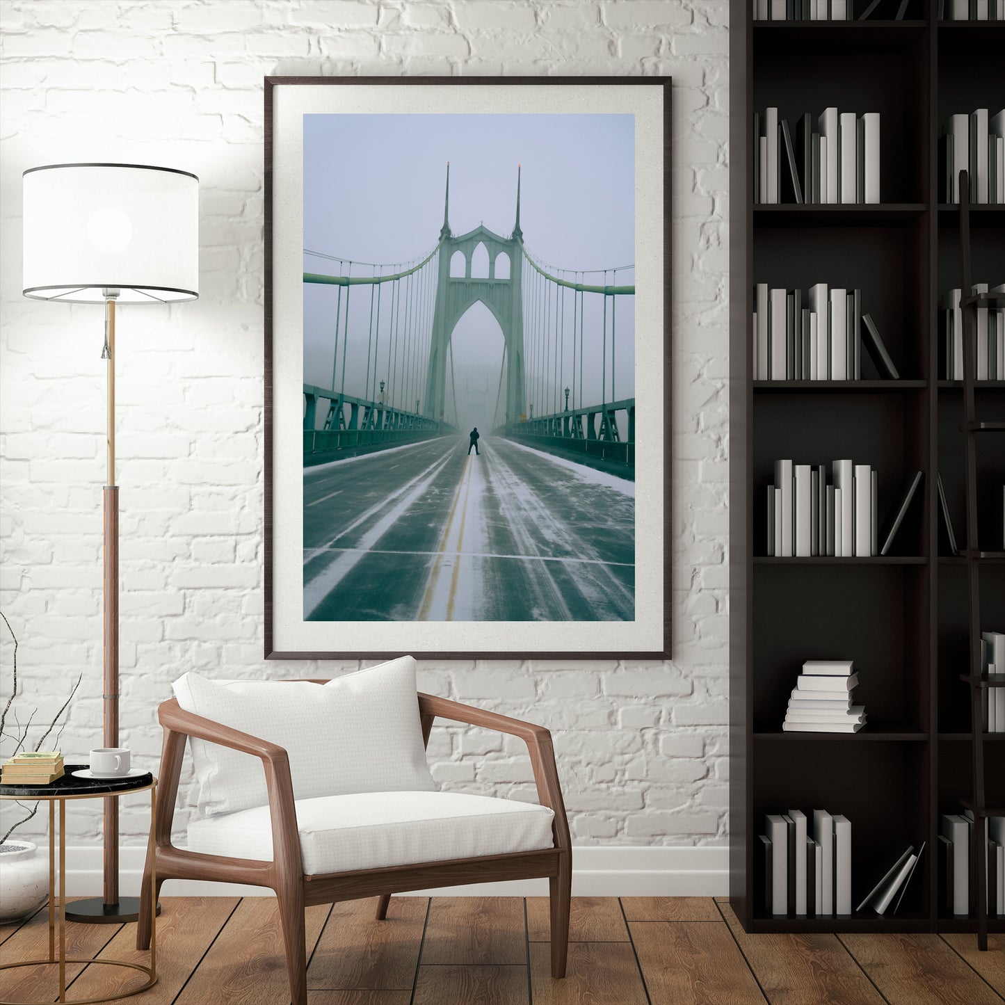 a framed photograph of a man standing in the middle of the st johns bridge during a snowstorm