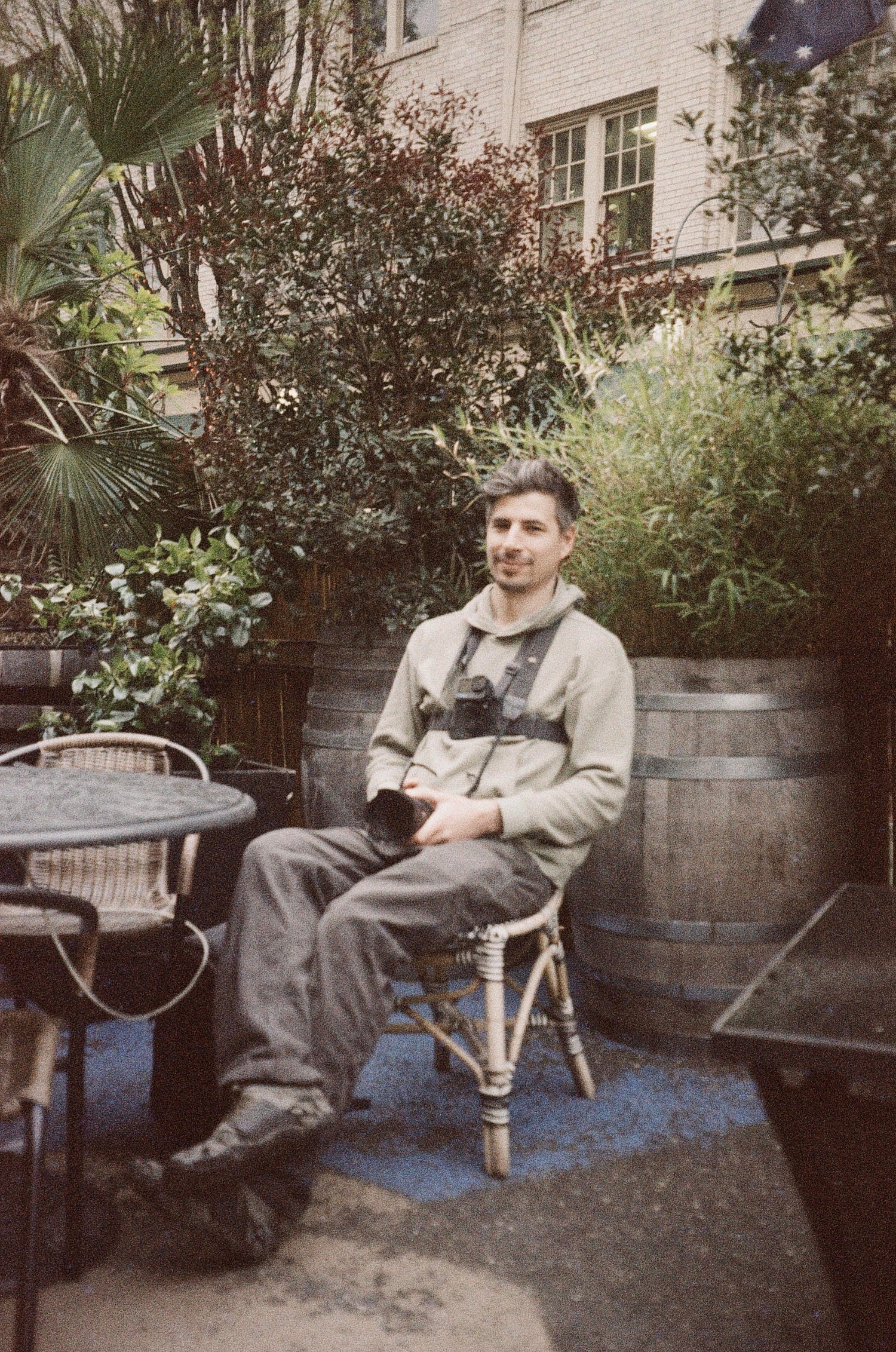 a photograph of the artist palebluewave sitting on a chair with his camer and gopro